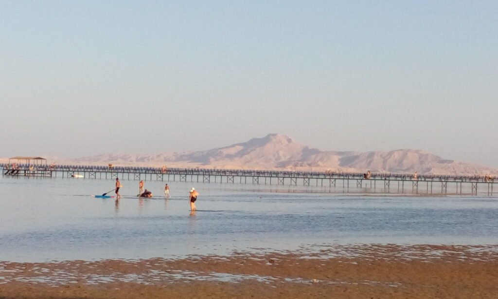 Long wooden jetty over shallow water in Sharm El Sheikh with the Sinai mountains behind