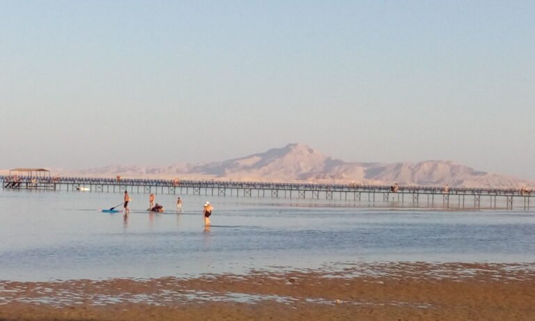 Long wooden jetty over shallow water in Sharm El Sheikh with the Sinai mountains behind