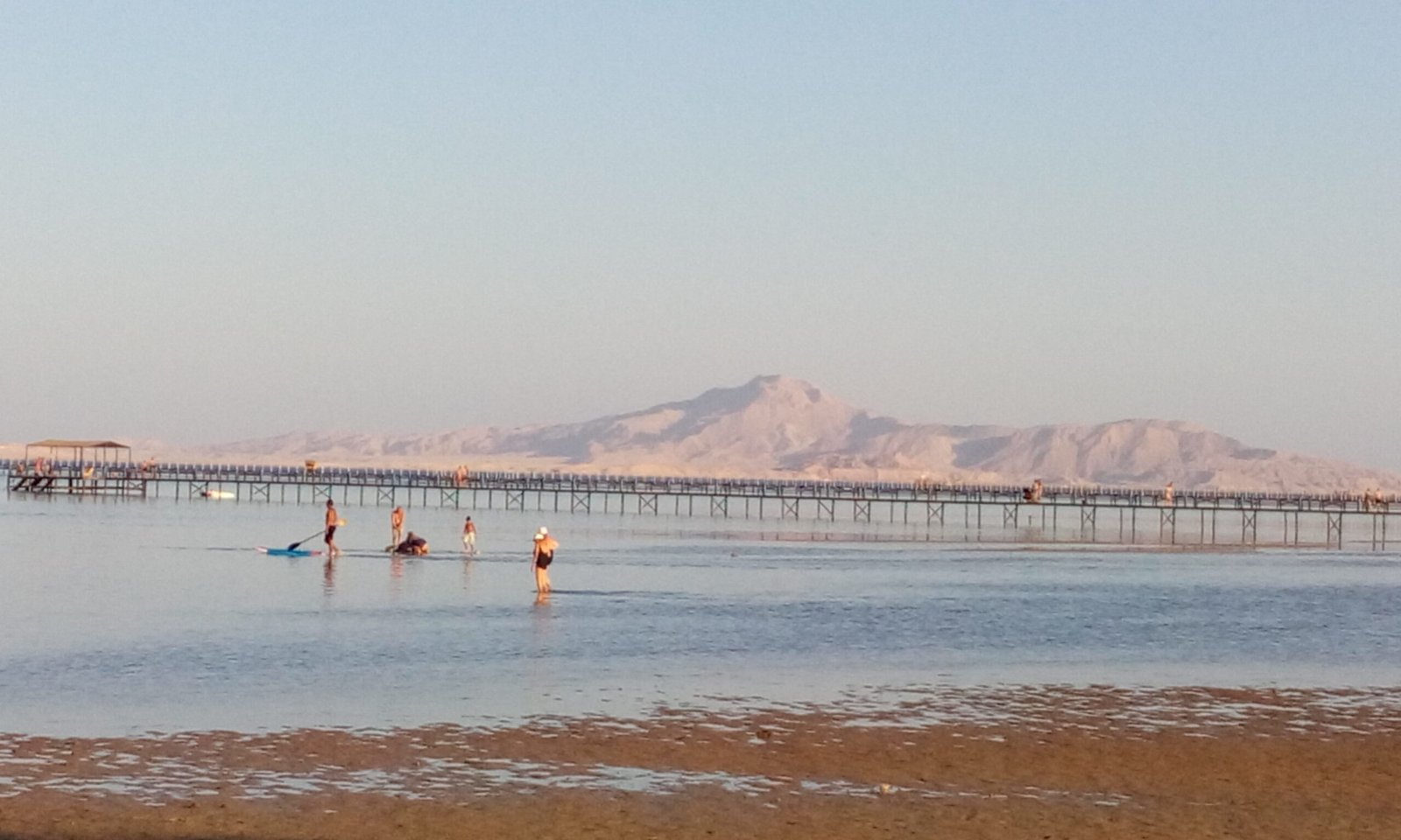 Long wooden jetty over shallow water in Sharm El Sheikh with the Sinai mountains behind